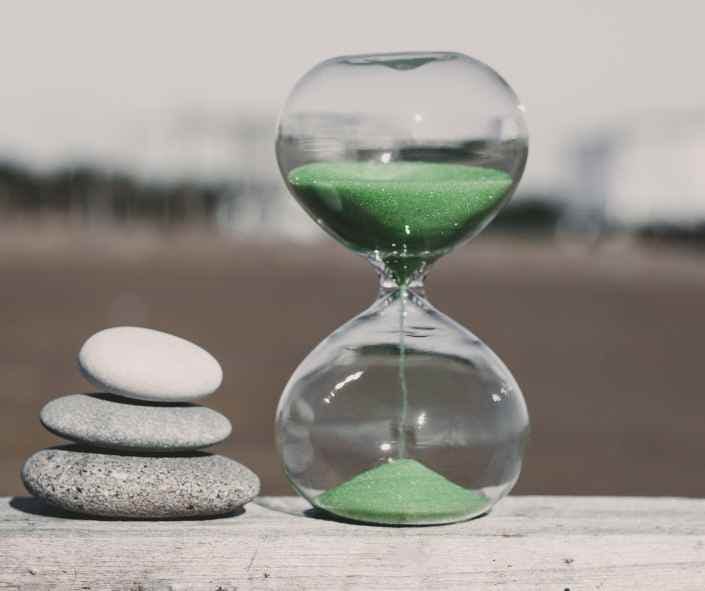 Pilled stone near a clock representing time
